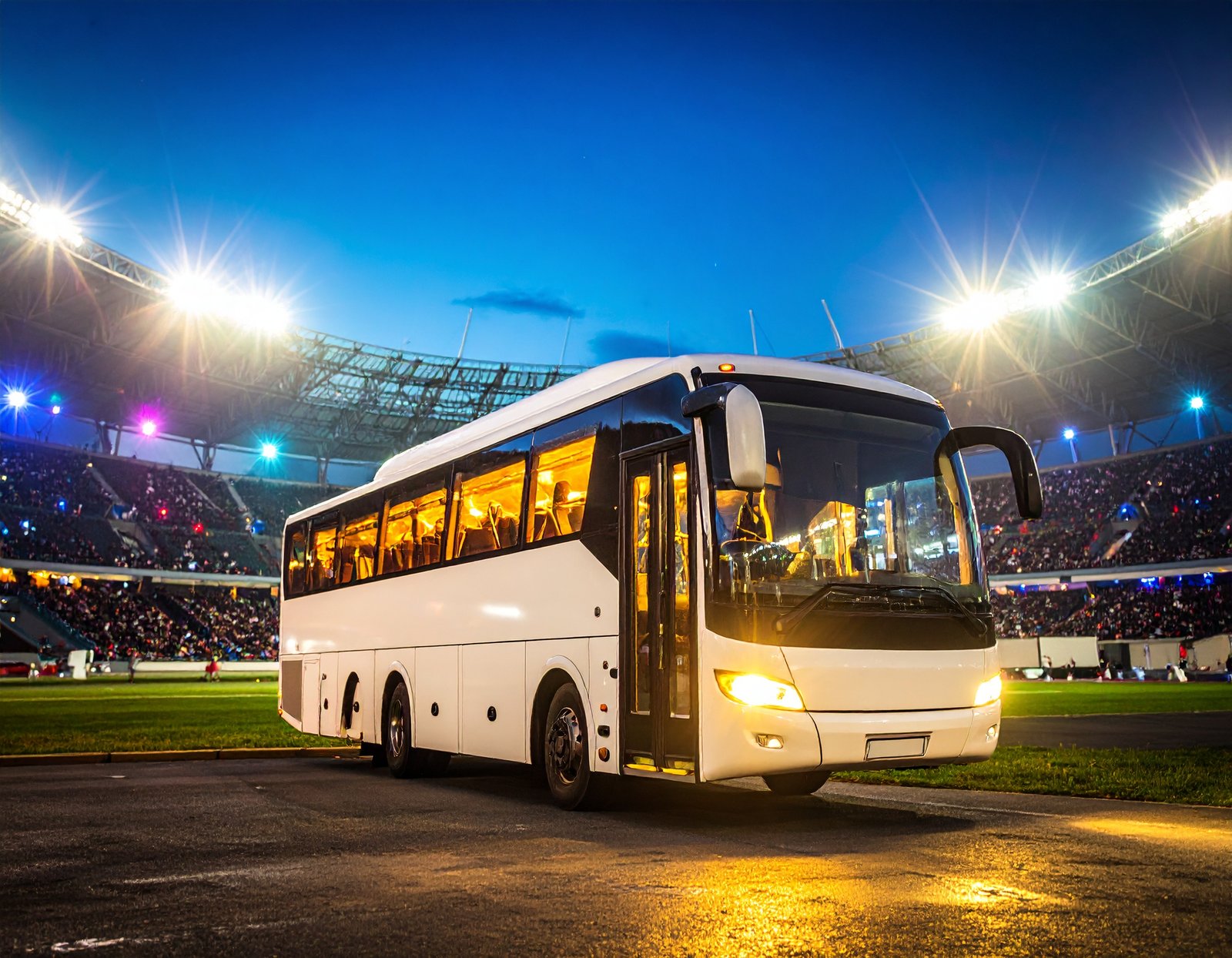 A charter bus arriving at a stadium
