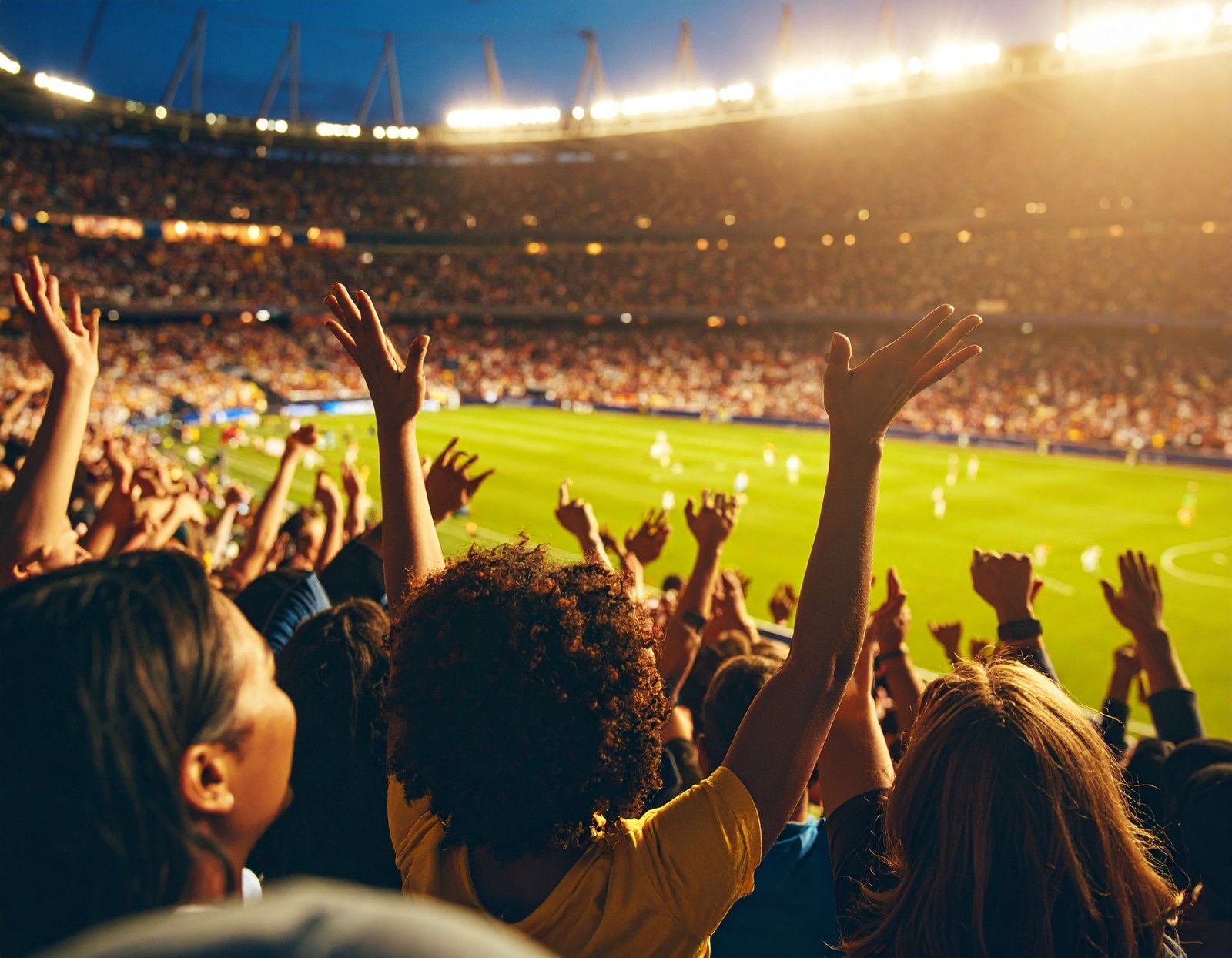 Football fans cheering in front of a bus